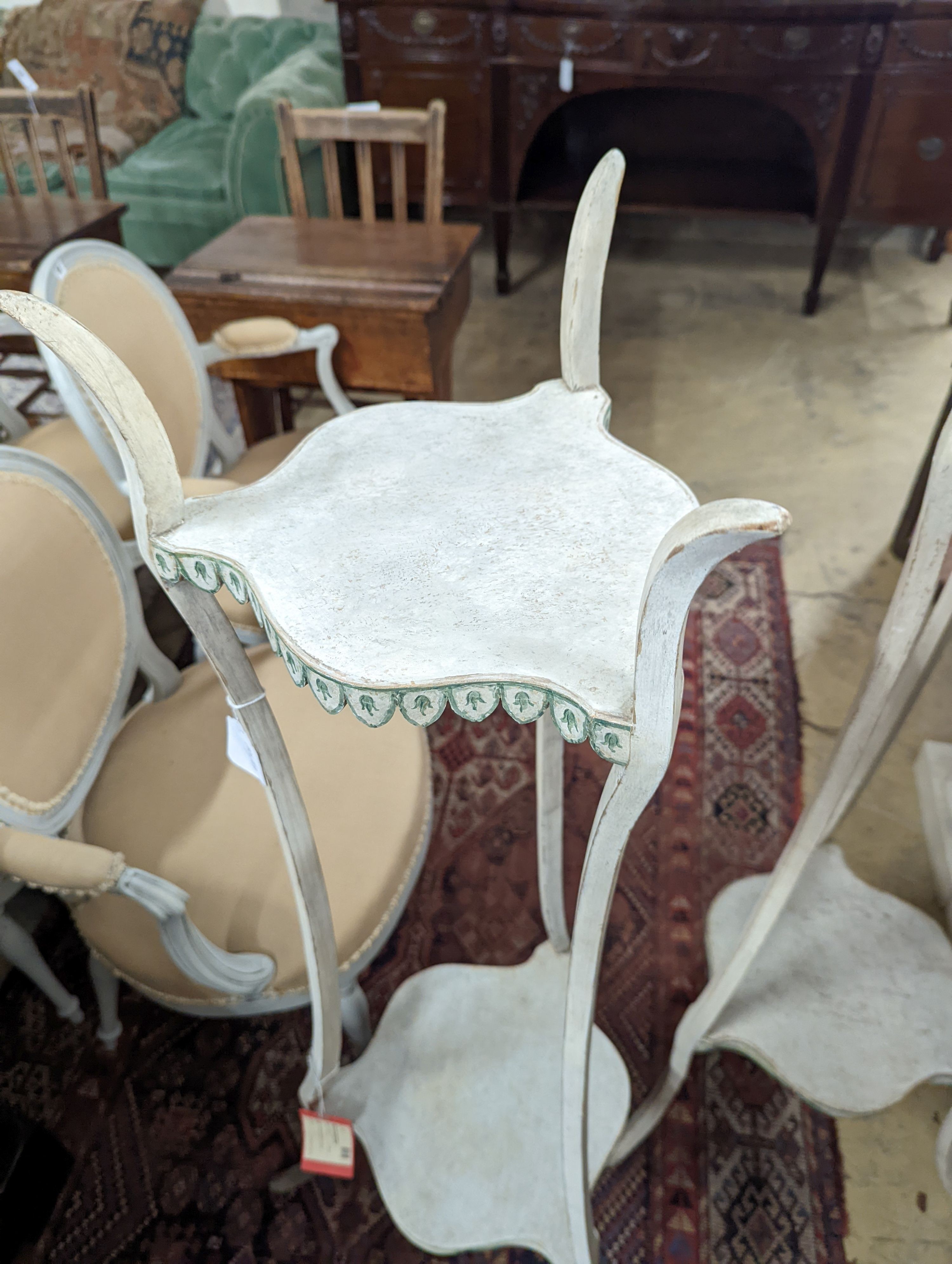 A pair of two-tier white painted plant stands, Colefax & Fowler, height 131cm